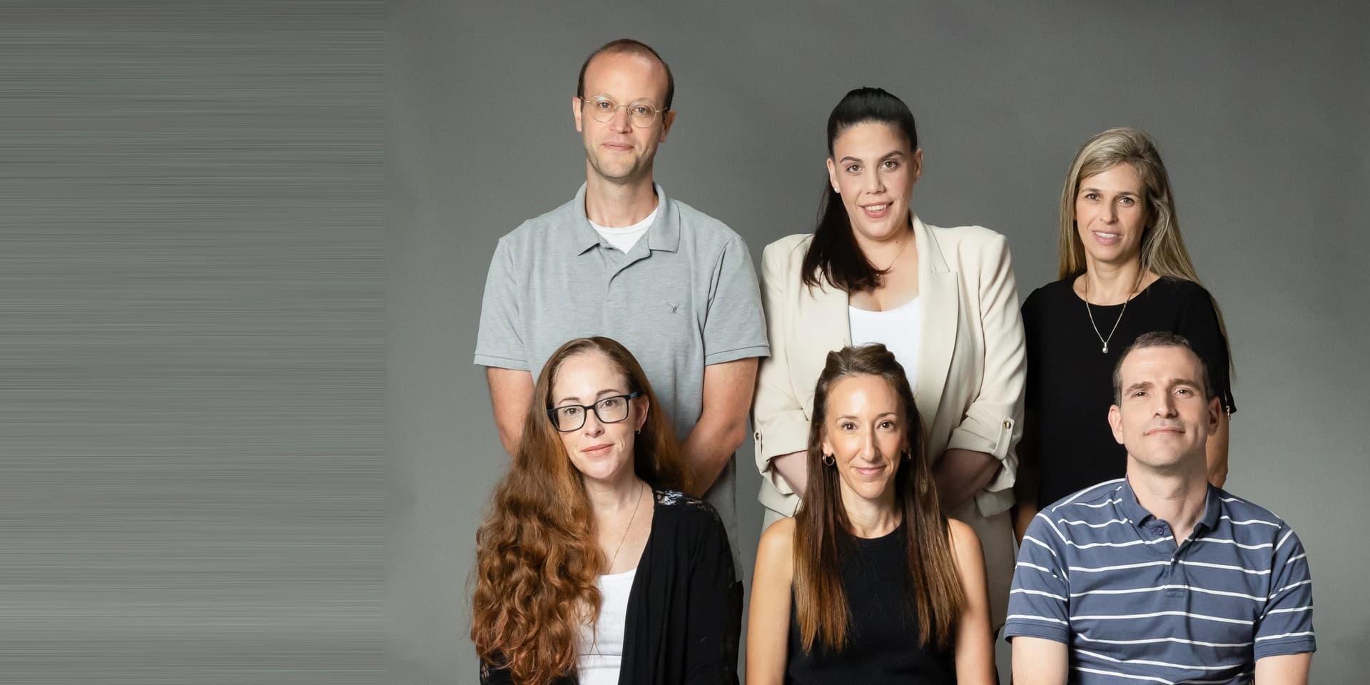 Six members of the firm photographed together against a plain backdrop.